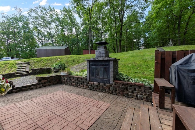 view of patio with an outdoor brick fireplace