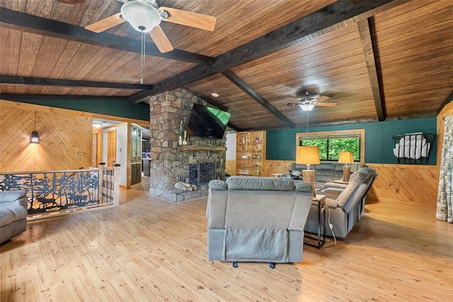 living room with a ceiling fan, wooden walls, wood ceiling, wood finished floors, and wainscoting