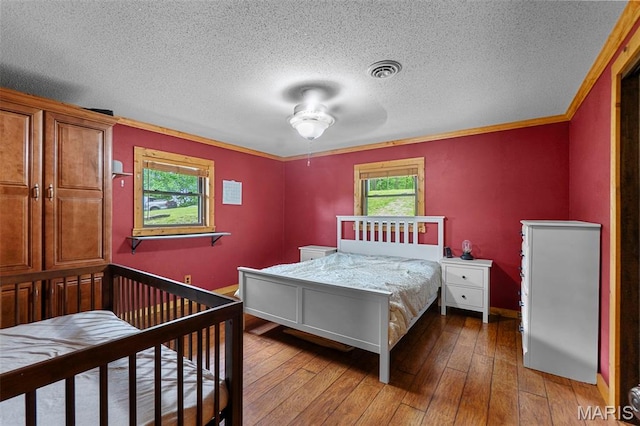 254 Rustic Hills Ln, Jackson, MO 63755 - bedroom featuring a textured ceiling, wood-type flooring, and baseboards
