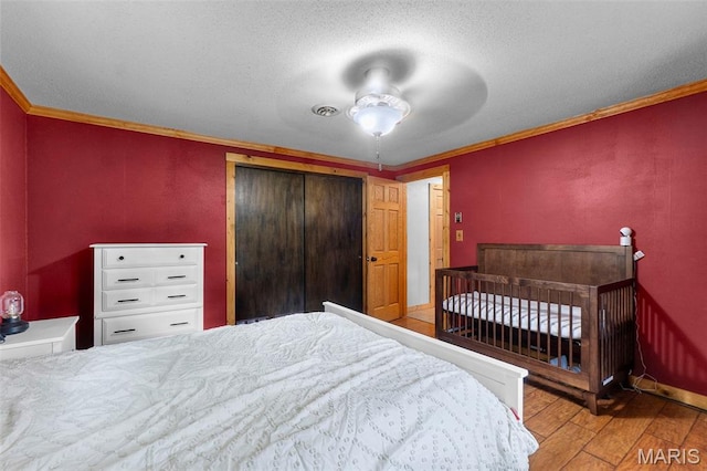 254 Rustic Hills Ln, Jackson, MO 63755 - bedroom with wood-type flooring, ornamental molding, a closet, baseboards, and a textured ceiling