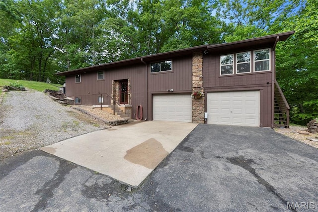 254 Rustic Hills Ln, Jackson, MO 63755 - view of front of house with asphalt driveway, stone siding, and an attached garage