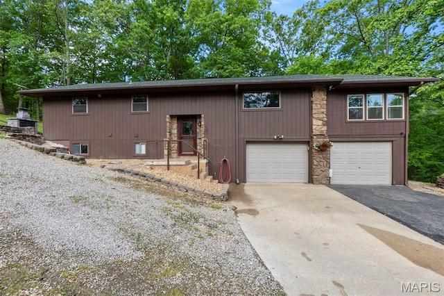 254 Rustic Hills Ln, Jackson, MO 63755 - view of front of property with asphalt driveway, a garage, and stone siding
