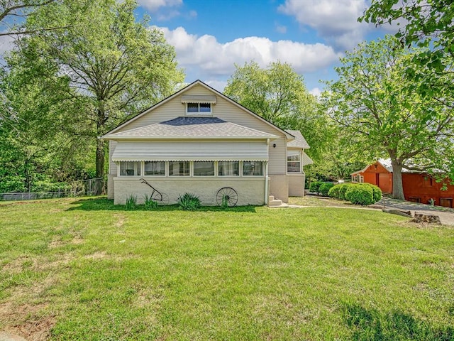 rear view of house featuring roof with shingles