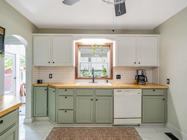 kitchen featuring green cabinets, white dishwasher, a sink, and butcher block counters
