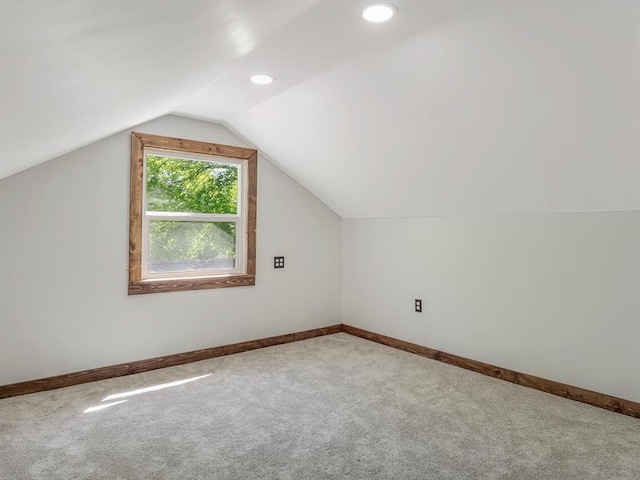additional living space featuring carpet, vaulted ceiling, baseboards, and recessed lighting