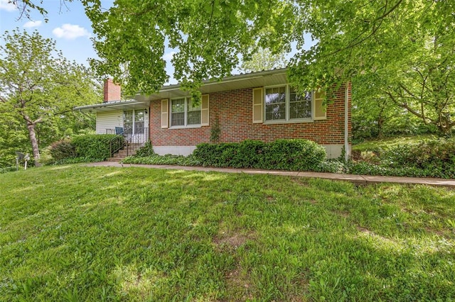 717 W Clement St, De Soto, MO 63020 - view of front of property featuring a chimney, brick siding, and a front lawn