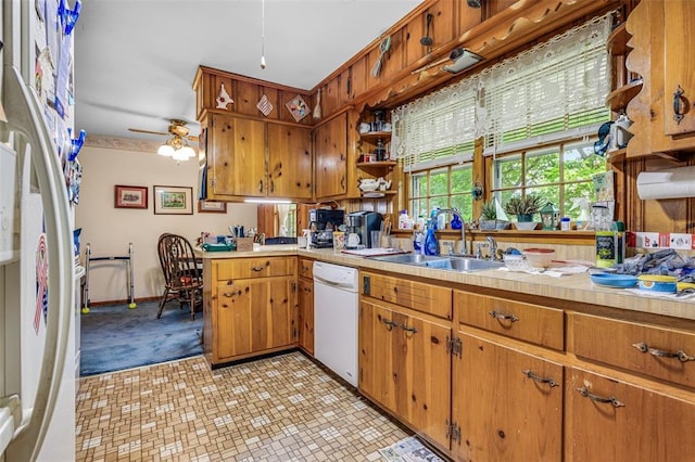 717 W Clement St, De Soto, MO 63020 - kitchen with white appliances, a sink, light countertops, and brown cabinetry