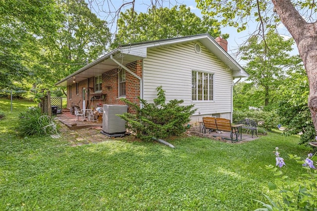 717 W Clement St, De Soto, MO 63020 - view of side of property featuring a chimney, central air condition unit, a yard, and a deck