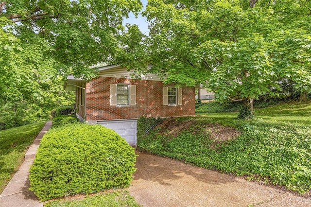 717 W Clement St, De Soto, MO 63020 - view of home's exterior with an attached garage, brick siding, and driveway