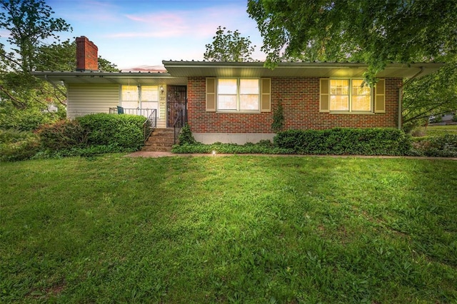 717 W Clement St, De Soto, MO 63020 - ranch-style house featuring a front yard, a chimney, and brick siding