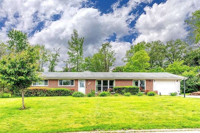 ranch-style house featuring a garage, a front yard, and brick siding