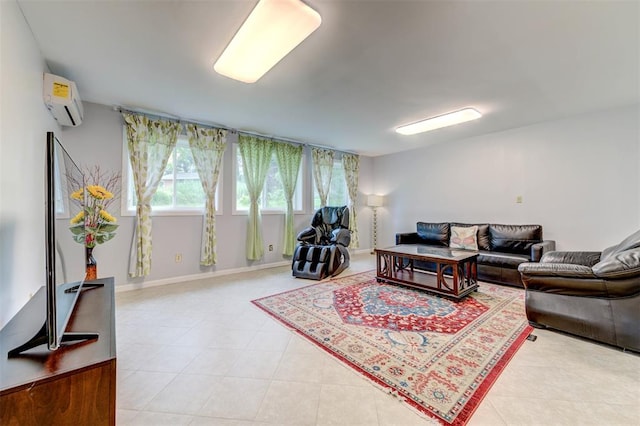 living area with a wall unit AC and light tile patterned floors