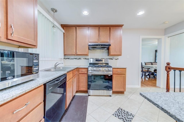 kitchen with appliances with stainless steel finishes, under cabinet range hood, a sink, decorative backsplash, and recessed lighting