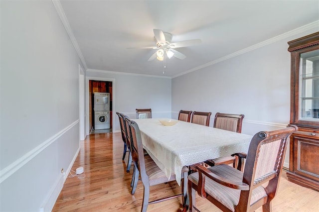 dining room featuring washer / dryer, ceiling fan, light wood-style flooring, crown molding, and baseboards