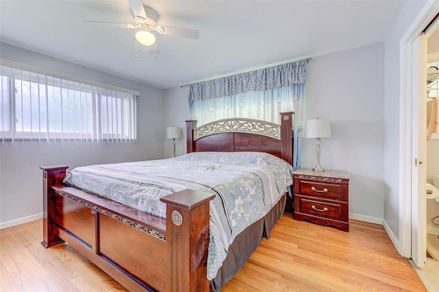 bedroom with light wood-style flooring, baseboards, and a ceiling fan