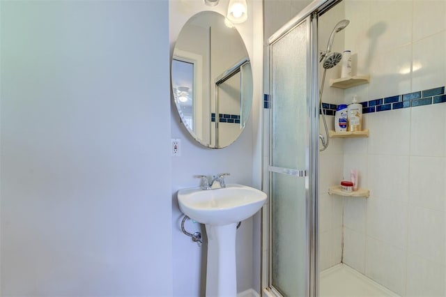 full bath featuring a stall shower and a sink