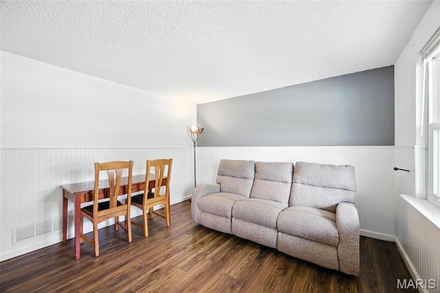 8544 Lake Dr, Cedar Hill, MO 63016 - living area with wood finished floors, a textured ceiling, and wainscoting