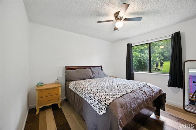 8544 Lake Dr, Cedar Hill, MO 63016 - bedroom with wood finished floors, a textured ceiling, and ceiling fan