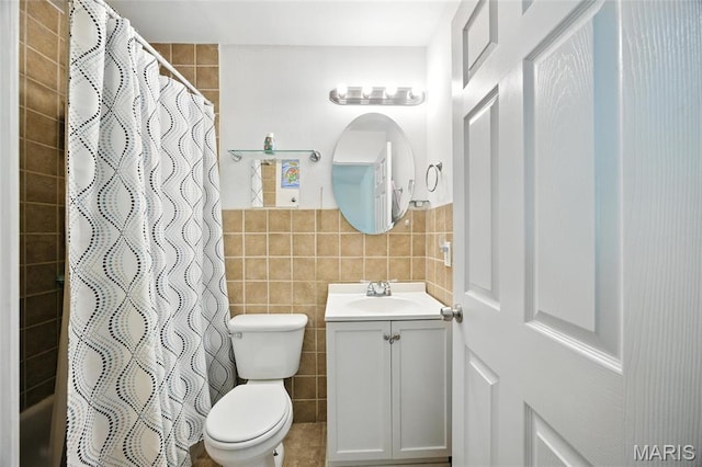 8544 Lake Dr, Cedar Hill, MO 63016 - full bathroom with tile walls, vanity, a shower with curtain, and a wainscoted wall