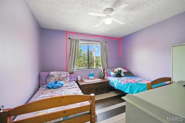 8544 Lake Dr, Cedar Hill, MO 63016 - bedroom featuring a textured ceiling, a ceiling fan, and wood finished floors