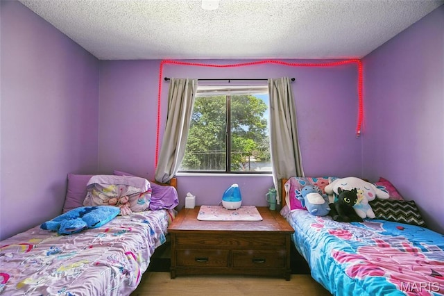 8544 Lake Dr, Cedar Hill, MO 63016 - bedroom featuring a textured ceiling and light wood-type flooring