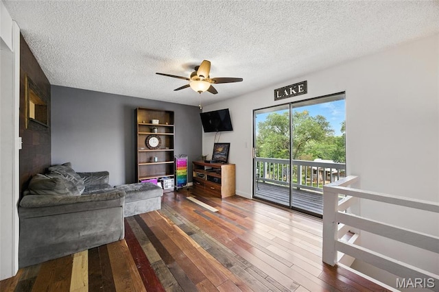 8544 Lake Dr, Cedar Hill, MO 63016 - living room featuring a ceiling fan, a textured ceiling, and wood-type flooring