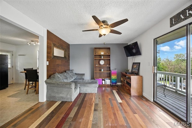 8544 Lake Dr, Cedar Hill, MO 63016 - living room with ceiling fan, a textured ceiling, and wood-type flooring