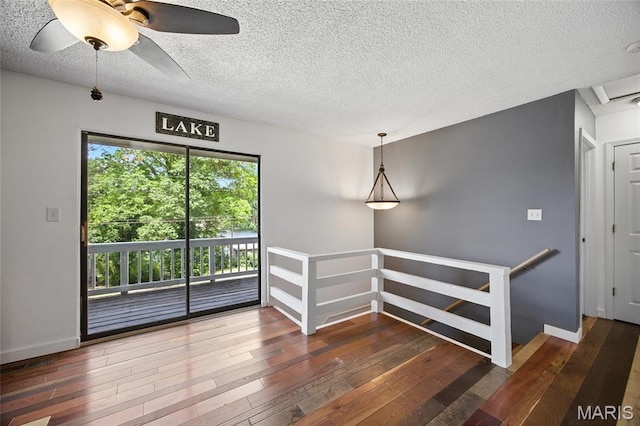 8544 Lake Dr, Cedar Hill, MO 63016 - empty room featuring wood-type flooring, a textured ceiling, and ceiling fan
