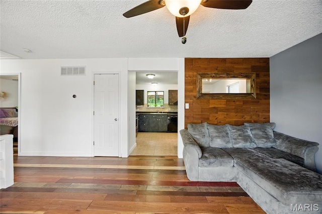 8544 Lake Dr, Cedar Hill, MO 63016 - living area with hardwood / wood-style floors, a ceiling fan, and a textured ceiling