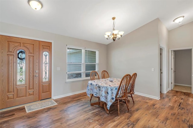 140 Glen Forest Dr, Troy, MO 63379 - dining space with a chandelier, baseboards, wood finished floors, and lofted ceiling