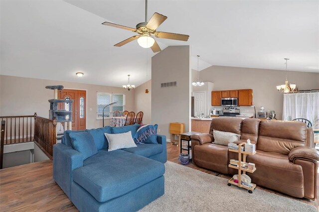140 Glen Forest Dr, Troy, MO 63379 - living area featuring a chandelier, vaulted ceiling, wood finished floors, and a ceiling fan