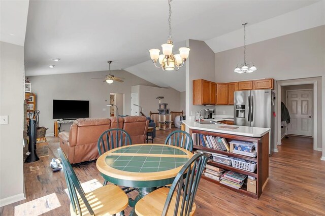140 Glen Forest Dr, Troy, MO 63379 - dining room featuring a chandelier, vaulted ceiling, ceiling fan, light wood-type flooring, and baseboards