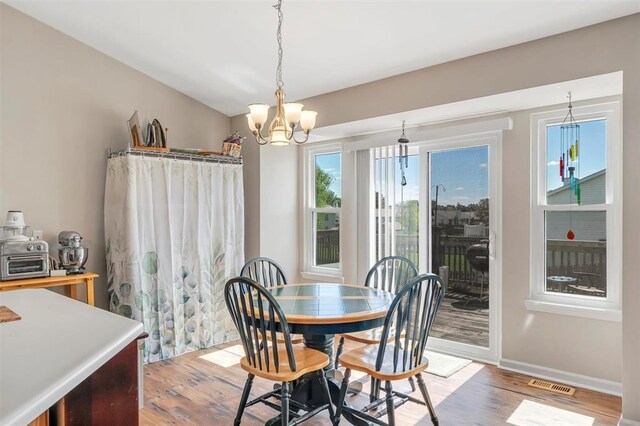 140 Glen Forest Dr, Troy, MO 63379 - dining space with a chandelier, light wood-style floors, and baseboards