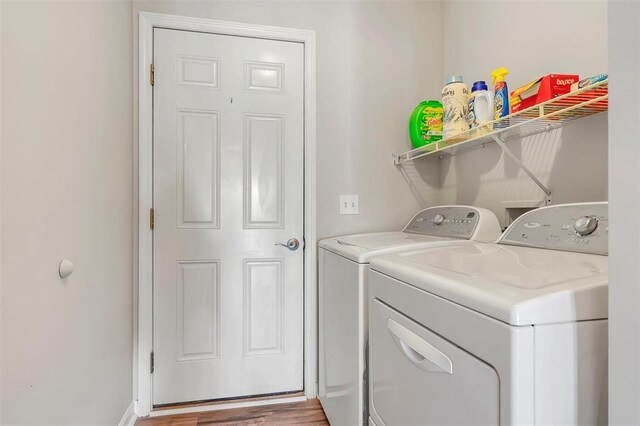 140 Glen Forest Dr, Troy, MO 63379 - laundry room with washer and clothes dryer and wood finished floors