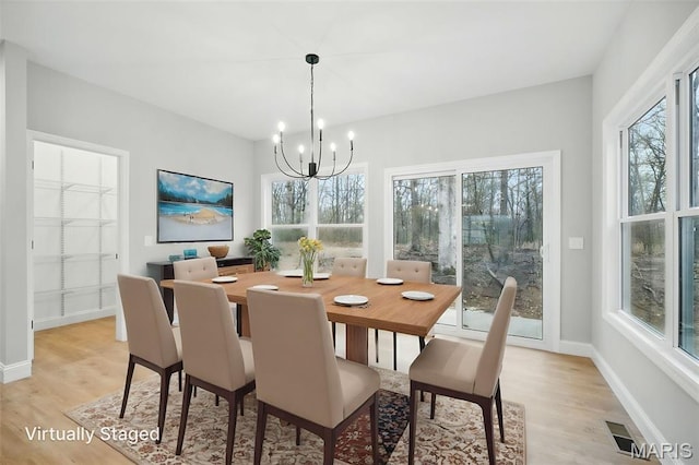 31998 Fairway Dr N, Foristell, MO 63348 - dining space with light wood finished floors and a chandelier