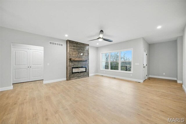 31998 Fairway Dr N, Foristell, MO 63348 - unfurnished living room featuring ceiling fan, light wood-style flooring, a stone fireplace, and recessed lighting