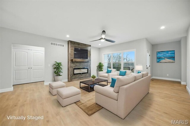 31998 Fairway Dr N, Foristell, MO 63348 - living room featuring light wood finished floors, ceiling fan, a fireplace, and recessed lighting