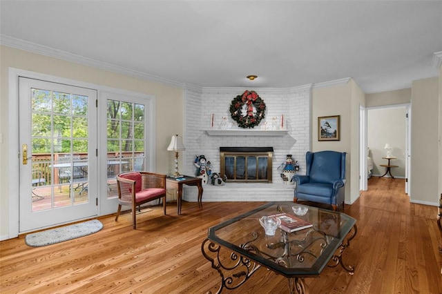 308 Wildbrier Dr, Ballwin, MO 63011 - living room with hardwood / wood-style floors, a fireplace, crown molding, and baseboards