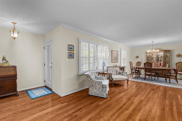 308 Wildbrier Dr, Ballwin, MO 63011 - entryway with a chandelier, light wood-type flooring, baseboards, and ornamental molding