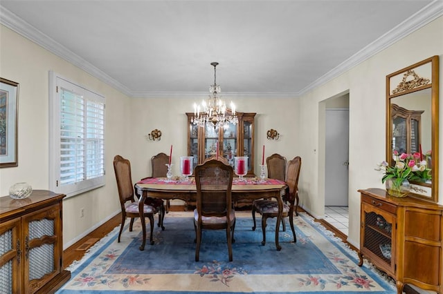 308 Wildbrier Dr, Ballwin, MO 63011 - dining room with a chandelier, wood finished floors, crown molding, and baseboards