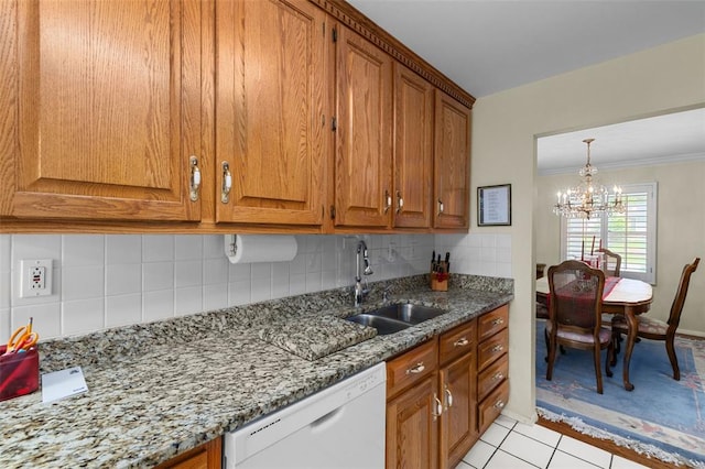 308 Wildbrier Dr, Ballwin, MO 63011 - kitchen featuring white dishwasher, a sink, brown cabinetry, a chandelier, and decorative backsplash