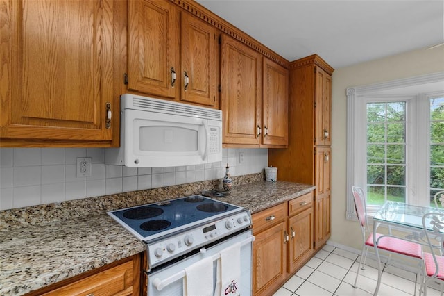 308 Wildbrier Dr, Ballwin, MO 63011 - kitchen with white appliances, tasteful backsplash, brown cabinetry, and light stone counters