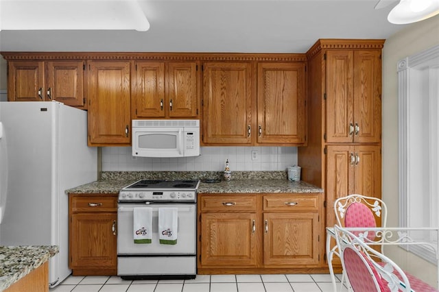 308 Wildbrier Dr, Ballwin, MO 63011 - kitchen with white appliances, brown cabinetry, and decorative backsplash
