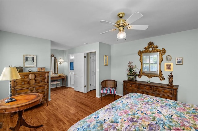 308 Wildbrier Dr, Ballwin, MO 63011 - bedroom featuring wood finished floors, ensuite bathroom, a ceiling fan, and baseboards