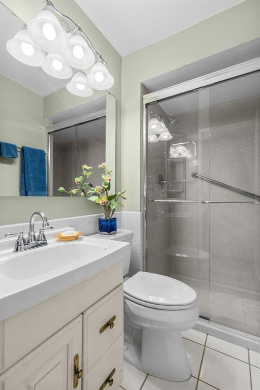 308 Wildbrier Dr, Ballwin, MO 63011 - full bath featuring tile patterned flooring, a stall shower, toilet, vanity, and tile walls