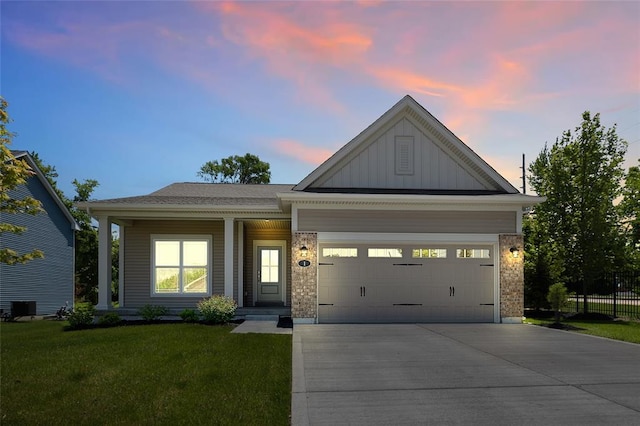 view of front of property with board and batten siding, concrete driveway, cooling unit, and a garage