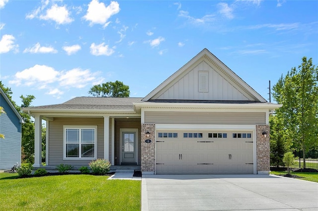 view of front of house featuring board and batten siding, driveway, a front yard, and an attached garage
