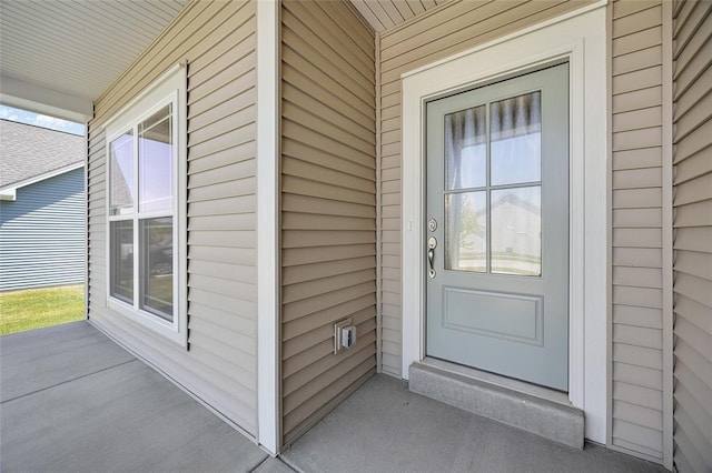 view of exterior entry featuring a porch
