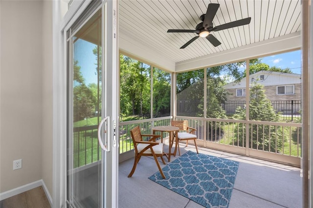 sunroom featuring ceiling fan