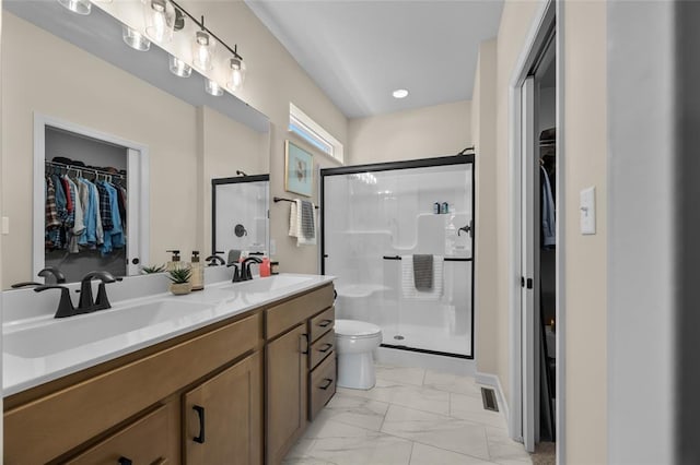 bathroom with toilet, a stall shower, marble look tile flooring, double vanity, and recessed lighting